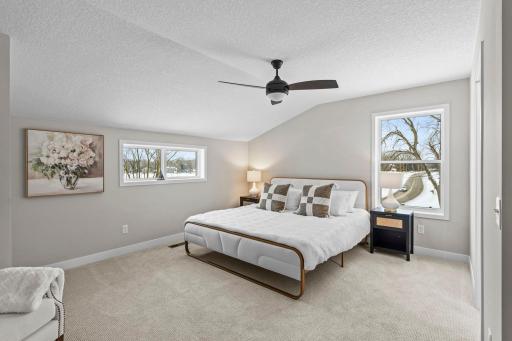 Upper level primary bedroom w/ views of Lake Owasso!