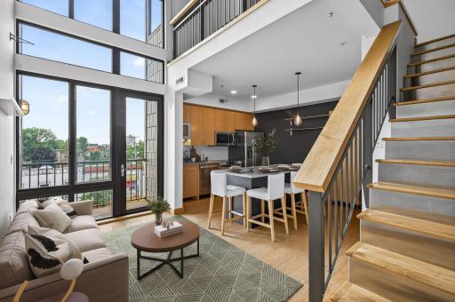 Two story south facing wall of windows allow natural light to pour in! (virtually staged)