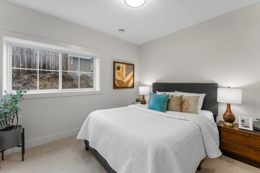 A fifth bedroom on this level is finished with cozy carpeting and windows for natural light.