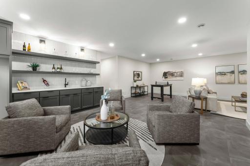 The adjacent wet bar includes wood shelving and a stylish tile backsplash.
