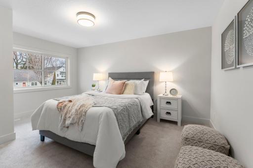 Bedroom two on the upper level is spacious and filled with natural light.