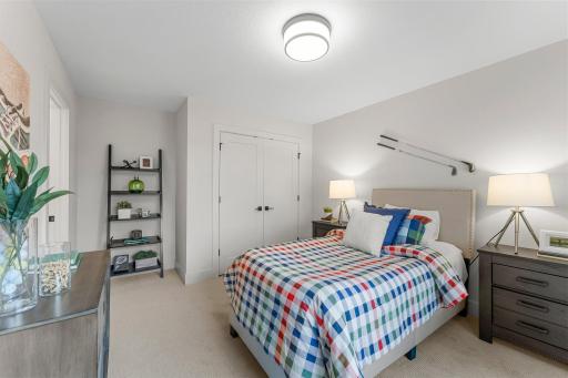 Bedroom three on the upper level provides additional closet space and comfortable carpeting.