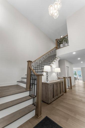 From the moment you step inside, you're welcomed into a grand foyer with soaring 19-foot ceilings and a striking chandelier that sets the tone for the rest of the home.