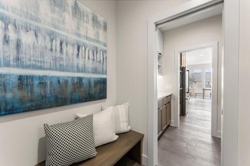 Functional and stylish, the mudroom offers cabinetry, counter space and a bench for seating.