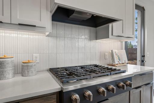 It features double wall ovens and a gas cooktop.