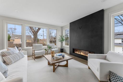 It features a sleek, remote-controlled gas fireplace with modern tile surround. Every detail has been thoughtfully considered for comfort and design.
