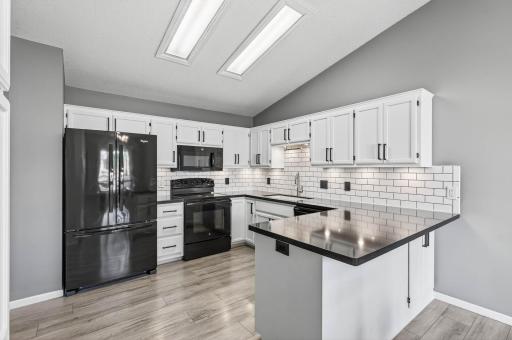 Kitchen, has beautiful subway tile, back appliances and granite countertop.