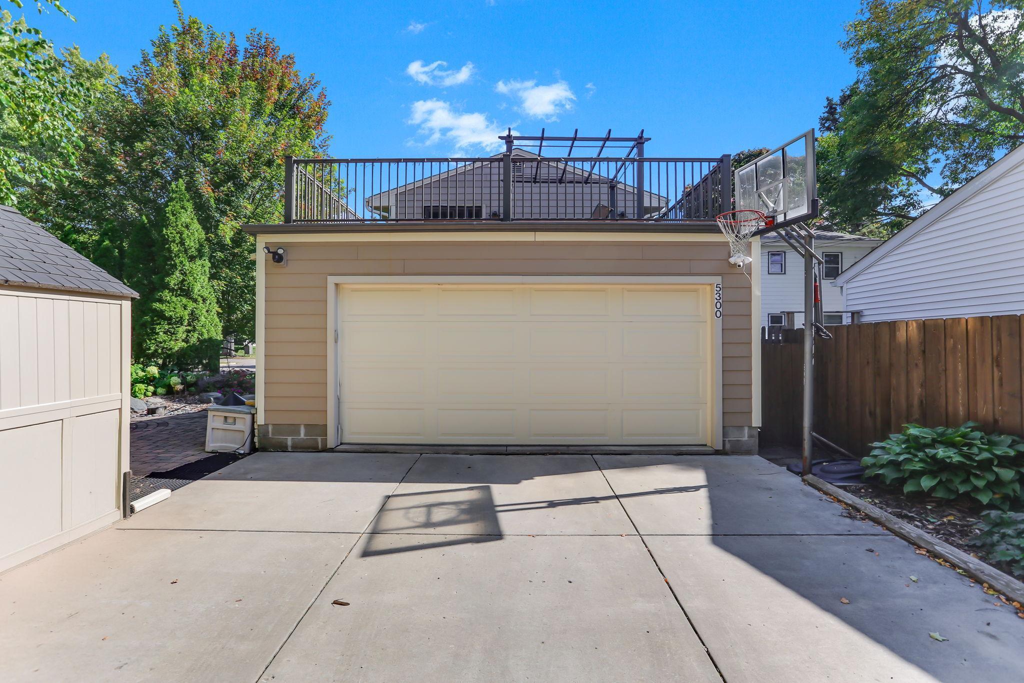 Two car attached garage with dog run along the south side of the property