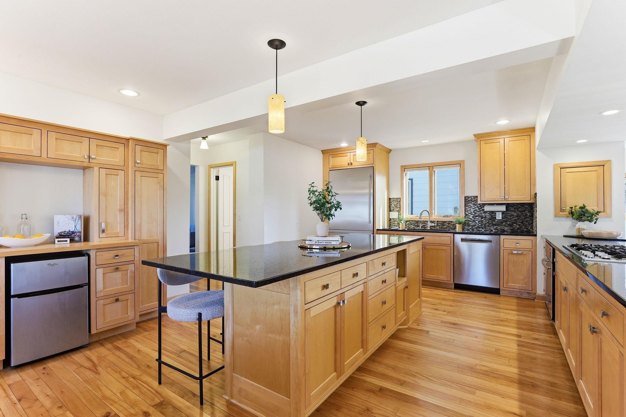 Kitchen with natural wood cabinets and granite countertops