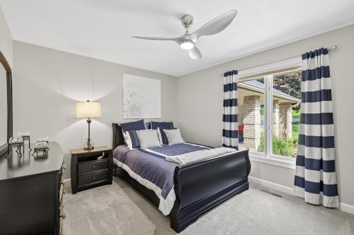 The third bedroom on the main floor has a large window that fills the space with natural light, this room is enhanced by a modern ceiling fan for year-round comfort.