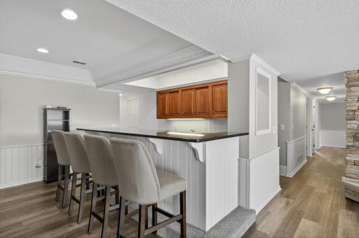 A wet bar adds convenience and style, making entertaining effortless. All of these spaces feature durable luxury vinyl plank (LVP) flooring, combining functionality with modern appeal.