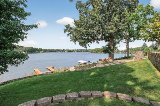 The professionally enhanced shoreline with riprap and a new irrigation system keeps the landscape lush and vibrant.