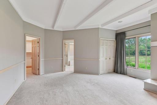 Primary suite with walk-in closet and full bathroom with a separate tub and shower