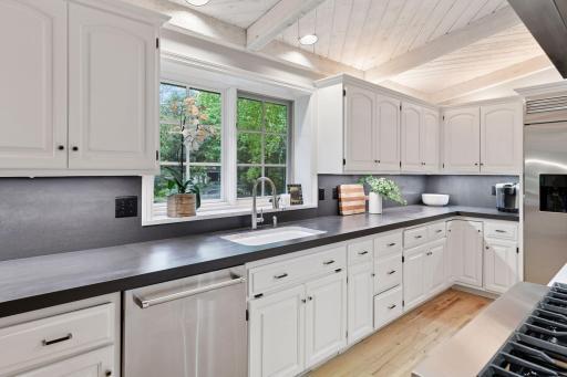 Chef-inspired kitchen featuring a quartz center island, double oven, French door refrigerator/freezer, built-in drawer microwave, and abundant prep space