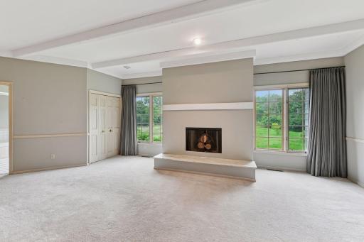 Primary bedroom with wood burning fireplace and lovely views.