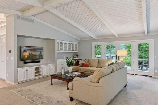 Photo for 461 Peavey Lane, Wayzata, MN 55391 - listing #6780111 Living room with builtins and walk out to the deck with wetland views