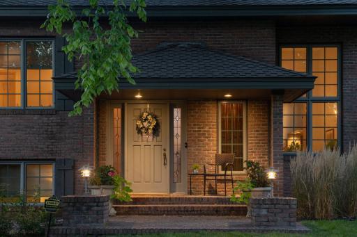 A gracious front porch area that is ideal for greeting guests or enjoying a cup of coffee