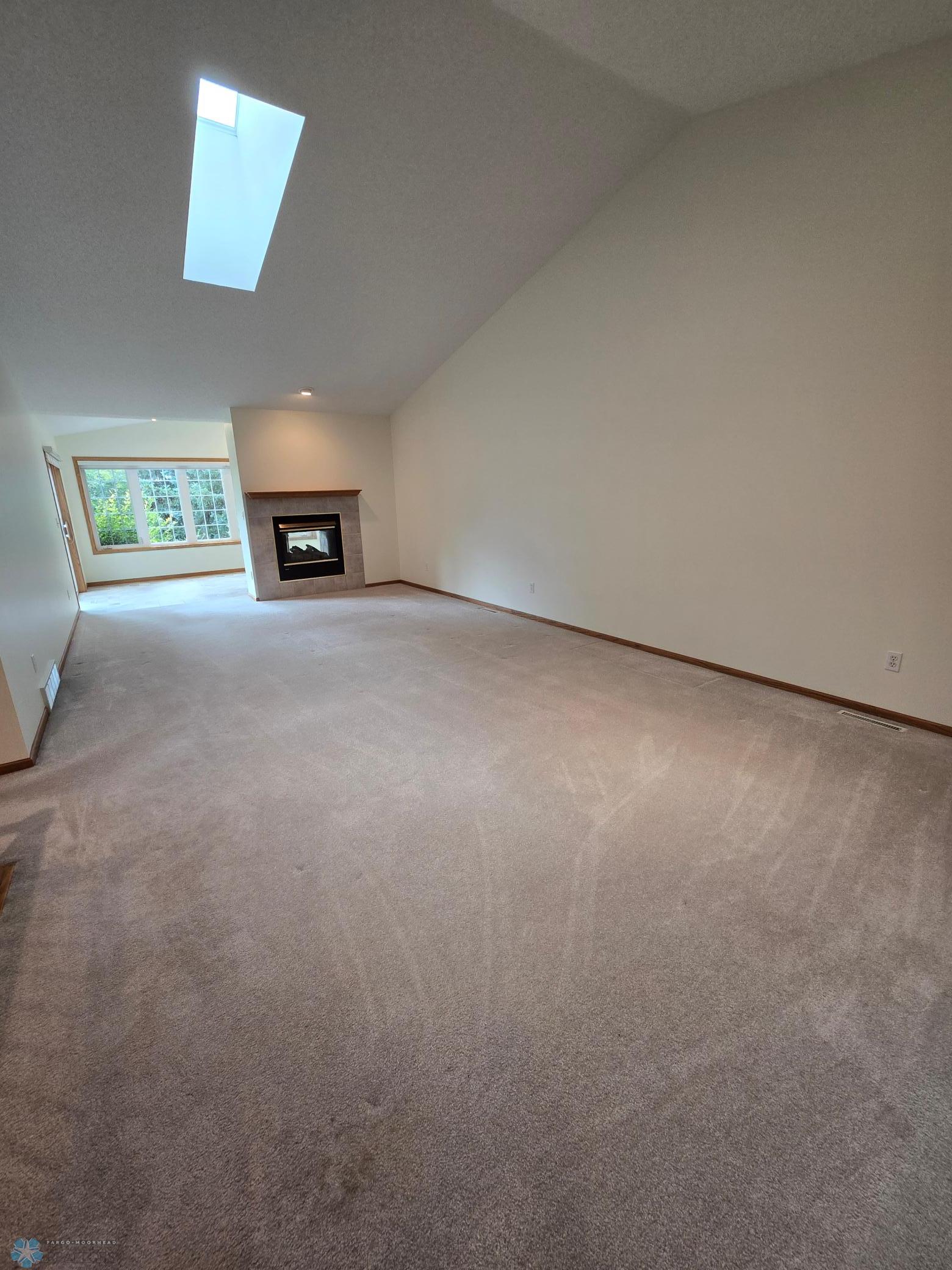 Living Dining Room with gas two way fp vaulted ceiling skylight.jpg