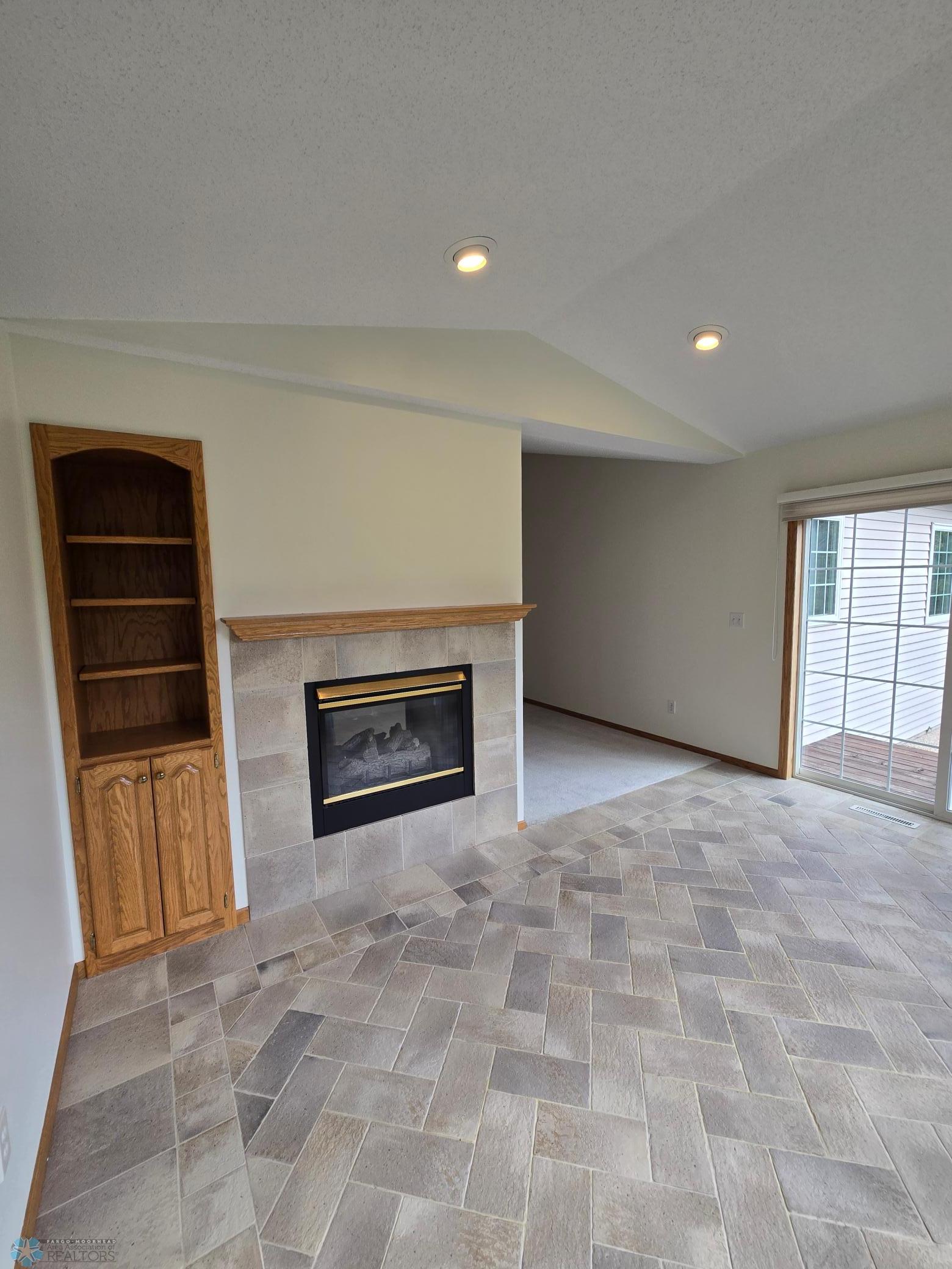 Sunroom shelving gas fp tile flooring.jpg