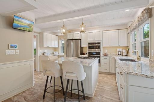 Wonderful kitchen layout , custom cabinets, view to back deck