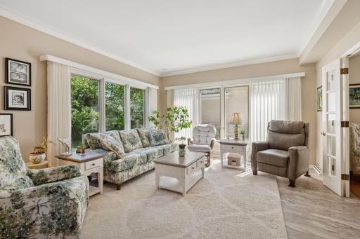 Large main floor family room with walls of windows to back yard
