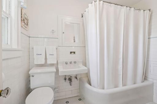 Original tiled shower surround and reglazed tub.