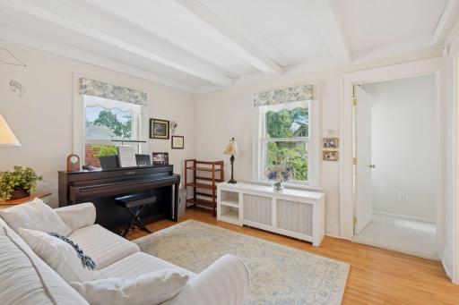Sitting room/tv room off the primary suite, maple floors