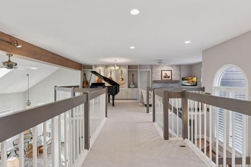 Versatile open loft/family room overlooking the main living area, ideal for media, music, or flex space