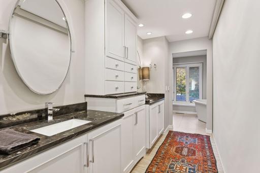 Spa-like primary bath with dual vanities, custom cabinetry, and refined finishes