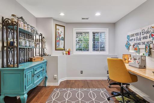Flexible lower-level bedroom currently used as a home office or creative workspace