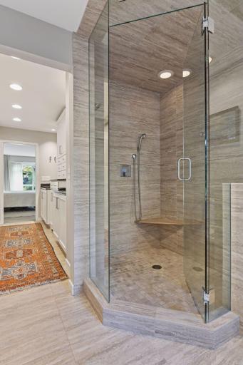 Luxurious primary bath with walk-in shower and separate soaking tub for a true spa experience