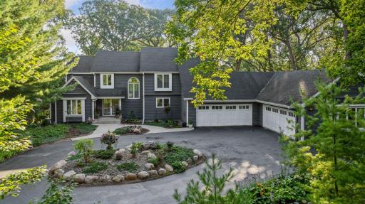 Beautifully landscaped front approach with circular drive and timeless curb appeal