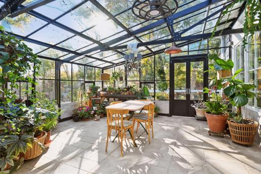 Spacious sun-filled conservatory with glass ceilings, garden views, and a tranquil setting for dining or relaxing