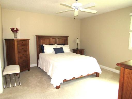 The primary bedroom has a ceiling fan and a huge walk-in closet.