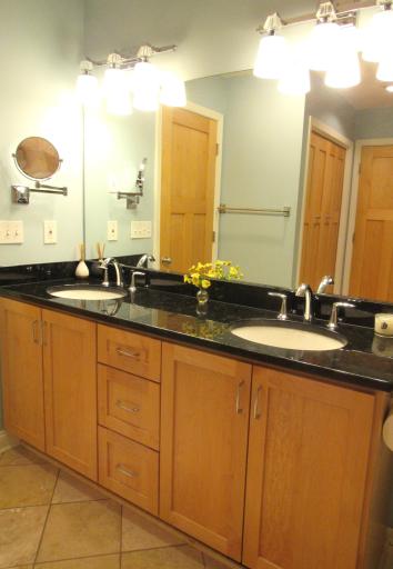 The main bath is perfect! Double sinks and a granite vanity, ceramic tiled flooring, heat lamp and a huge linen closet. Both faucets were replaced 11/2022 and are Kohler.