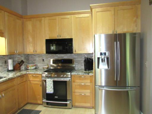 The cabinet above the fridge has pull-outs!
