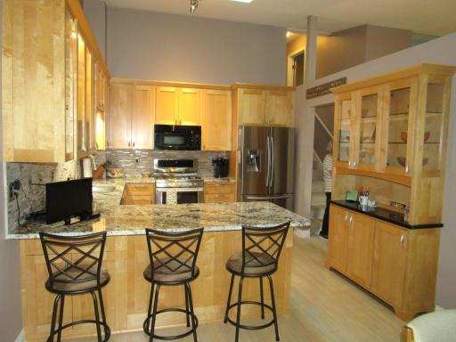 GE Profile combination microwave & oven, Electrolux gas stove w/warmer tray, Kitchenaid dishwasher and Samsung refrigerator with water dispenser. Built-in cabinet with shelves (there is a light inside above the top shelf) and extra storage below.