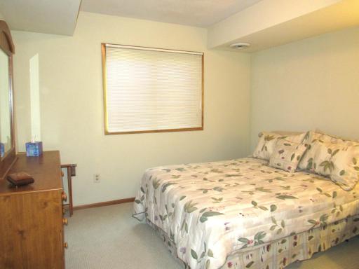 The lower level bedroom has french doors that open to the family room.