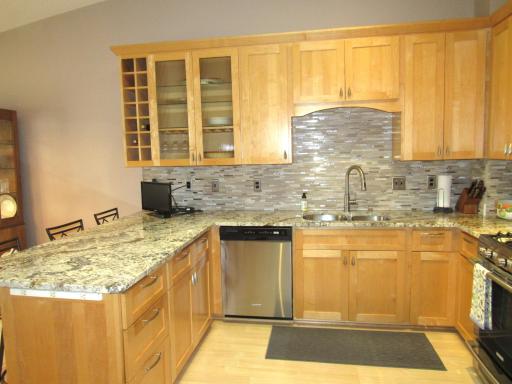 There are 2 cutting boards, pull-out garbage/recycle bins, built-in spice rack, appliance storage and even pull-outs above the refrigerator. The sky light adds natural light.