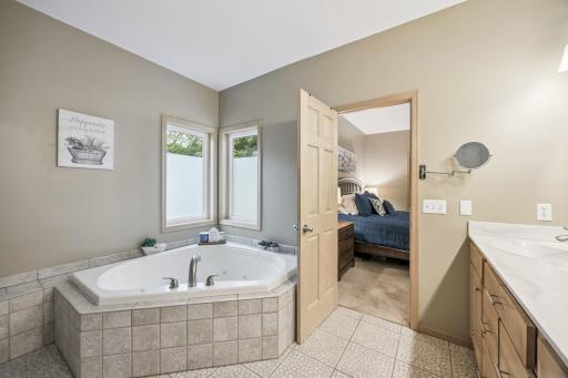 Owner's ensuite with dual vanity, tile flooring, soaking tub and shower.