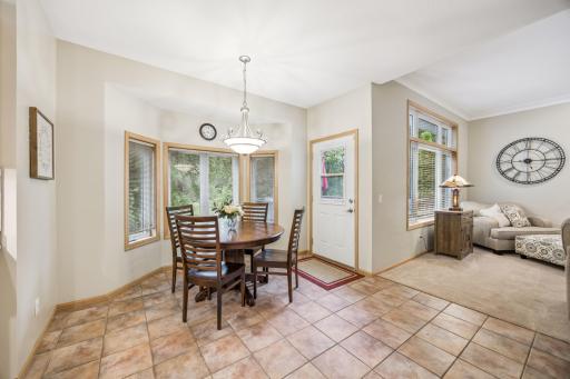 The dining area flows seamlessly from the living room, featuring a bay window and access to the deck overlooking the private backyard.