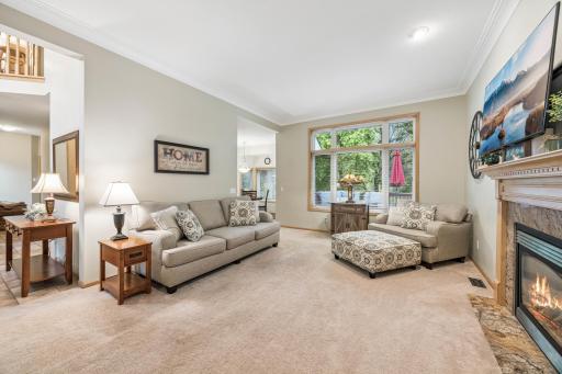 A gas-burning fireplace, crown molding, and oversized windows enhance the charm of the main floor living area.