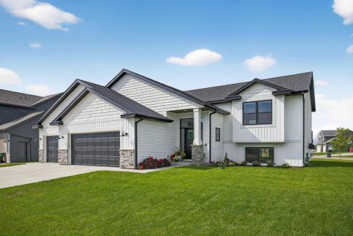 Front view of this sunny 5-bedroom, 2 3/4 bath home, equipped with three car garage..