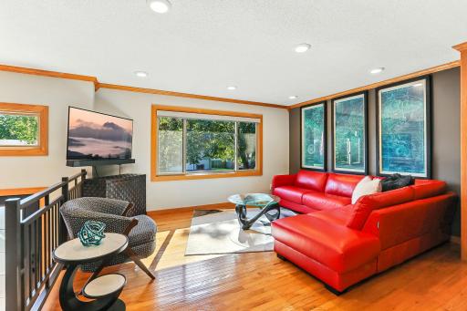 Large living room window offers ample light throughout the upper space. Also features a custom window above new entry door.