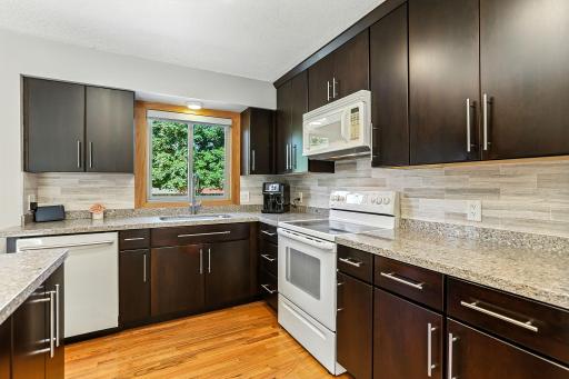 Kitchen features Quartz counters, cherry soft close cupboards and marble backsplash