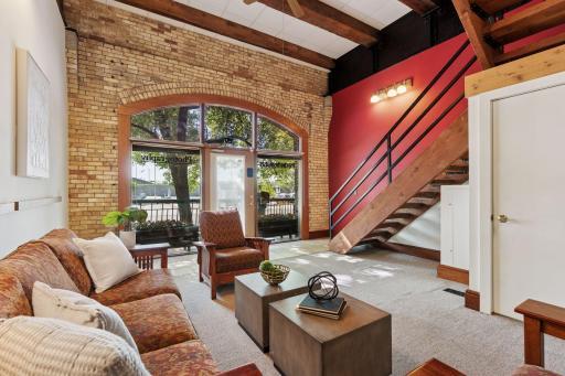The exposed brick entry with its impressive arched glass is beautiful