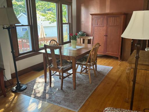 A wall of windows fills the dining room with light.