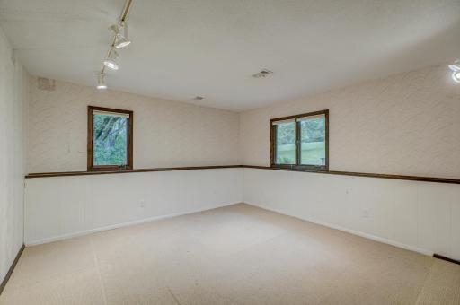 The fourth bedroom located in the lower level provides ample space and flexibility, perfect for guests when hosting