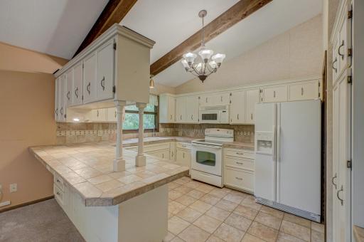 The kitchen offers ample storage with abundant cabinetry, perfect for keeping everything organized