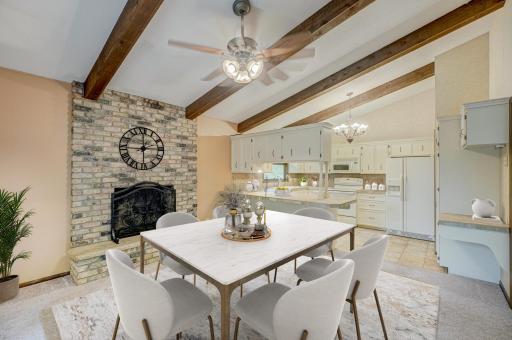 Designed for both comfort and style, the vaulted kitchen opens to a dining area anchored by a warm, inviting fireplace